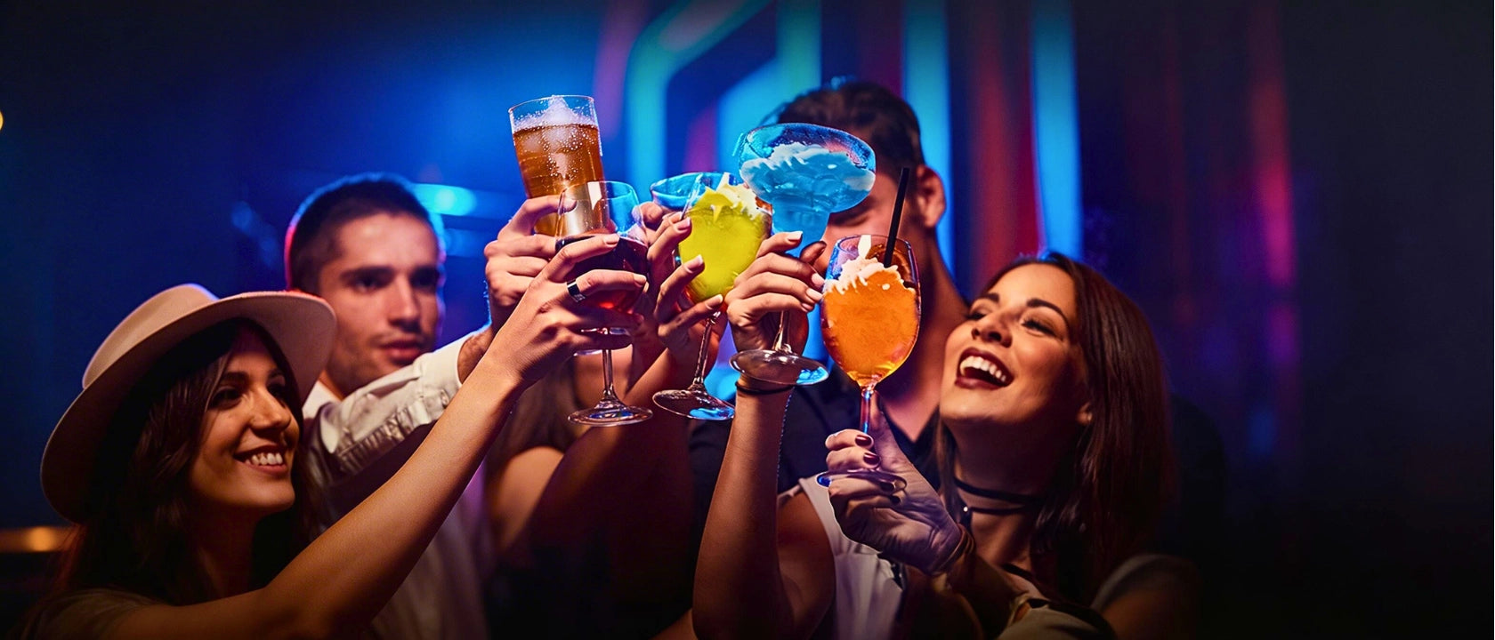 A group of happy customers toasting with colorful frozen margaritas and slushies at a vibrant party. Representing the high-volume sales and impulse profits generated by Tenshine commercial beverage equipment.