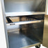 Spacious interior storage cabinet base of the commercial fry station, perfect for storing extra paper bags and kitchen supplies.