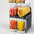 Commercial 2-bowl 30L slushy machine and margarita maker dispensing red and yellow frozen drinks on a white background.