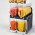 Commercial 2-bowl 30L slushy machine and margarita maker dispensing red and yellow frozen drinks on a white background.