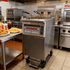 Commercial electric deep fryer cooking crispy fried chicken and french fries