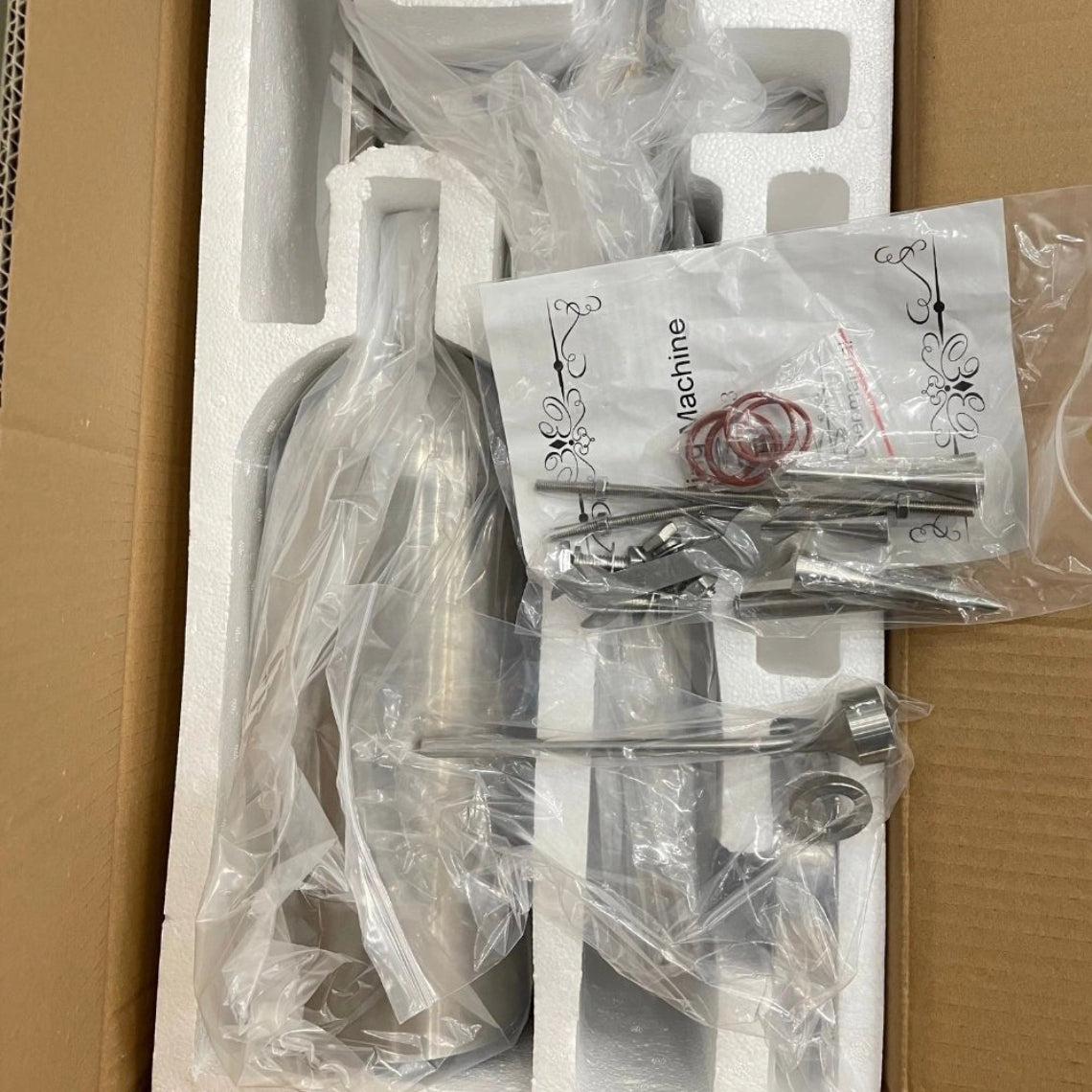 Securely packaged manual pastry filler in foam-lined box with accessories bag and user manual, ensuring safe shipping.